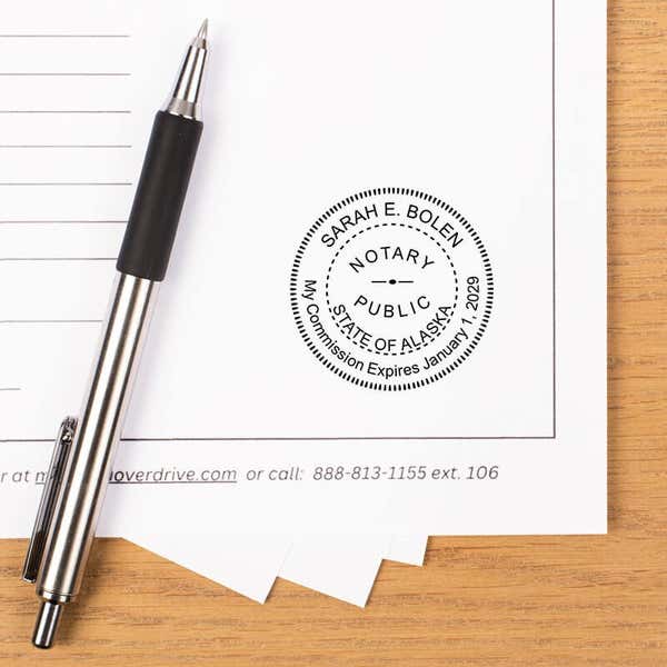 Alaska stamp impression on white sheet of paper.