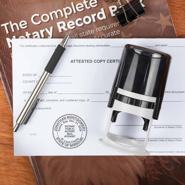 Notary stamp and record book on notarized legal document.