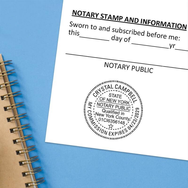 Notary public stamp impression on signed document above notebook