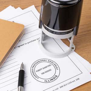 A self-inking stamp placed next to the State of Illinois Geologist Seal at the bottom of a document