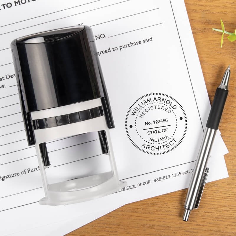 The State of Indiana Architect Seal on a document next to the self-inking stamp and a pen
