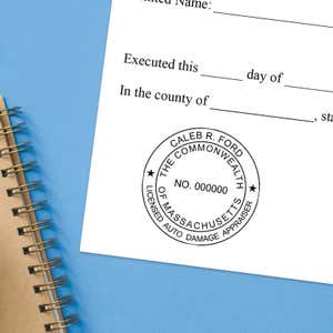 The Massachusetts Auto Appraiser stamp impression on a document next