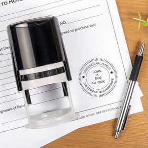 The State of New Hampshire Architect Seal at the bottom of a document with the self-inking stamp and a pen