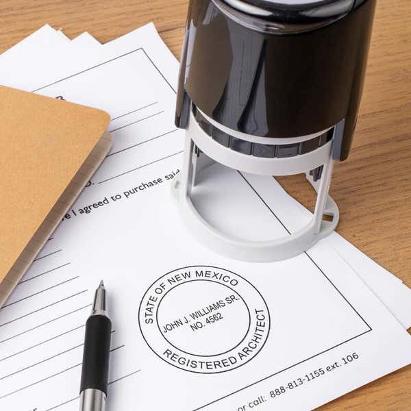 A self-inking stamp placed next to the State of New Mexico Architect Seal at the bottom of a document