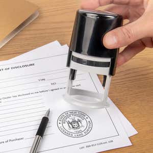 The State of New York Land Surveyor Seal being used on a document