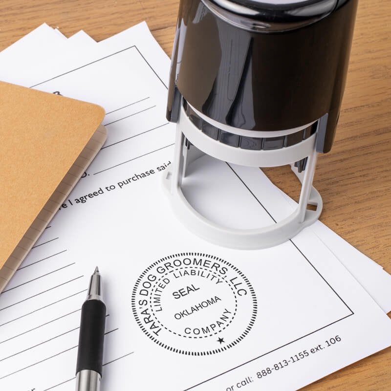 The State of Oklahoma LLC Corporate Seal on a document next to a stamp