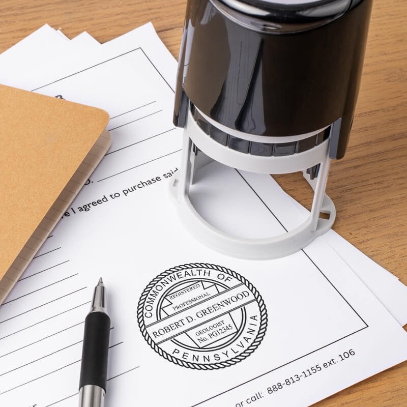 The State of Pennsylvania Geologist Seal at the bottom of a document next to the self-inking stamp and a pen