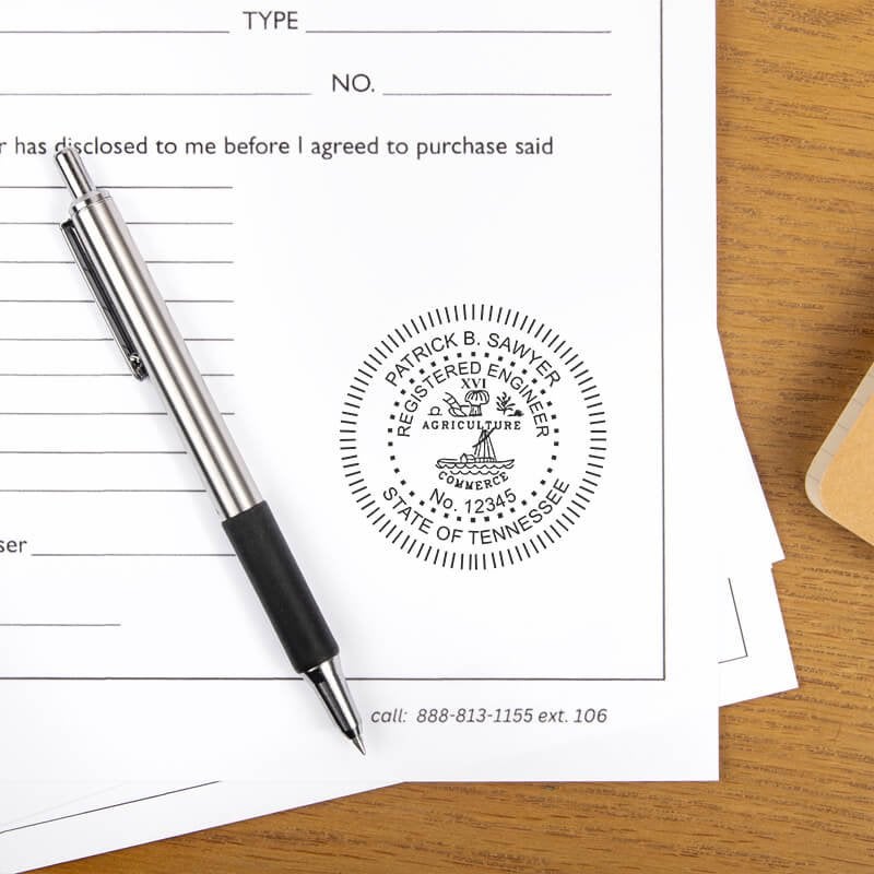 The impression of the State of Tennessee Engineer Seal on a document next to a pen