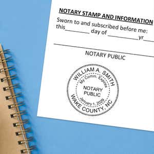    North Carolina notary stamp impression on white paper on a blue notebook. 