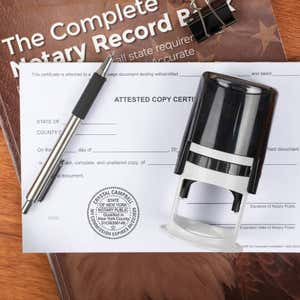 Notary tool resting on a stamped certified document for legal records.