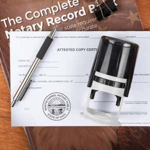 Ohio notary stamp on affidavit with pen and record book on wooden desk.