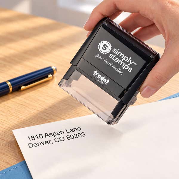 Hand holding the 2 Line Stamp