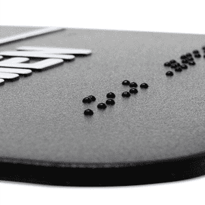 Close up on the braille on the ADA restroom sign