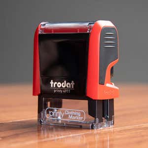 The Trodat Printy 4911 clothing stamp comes in a stylish red case