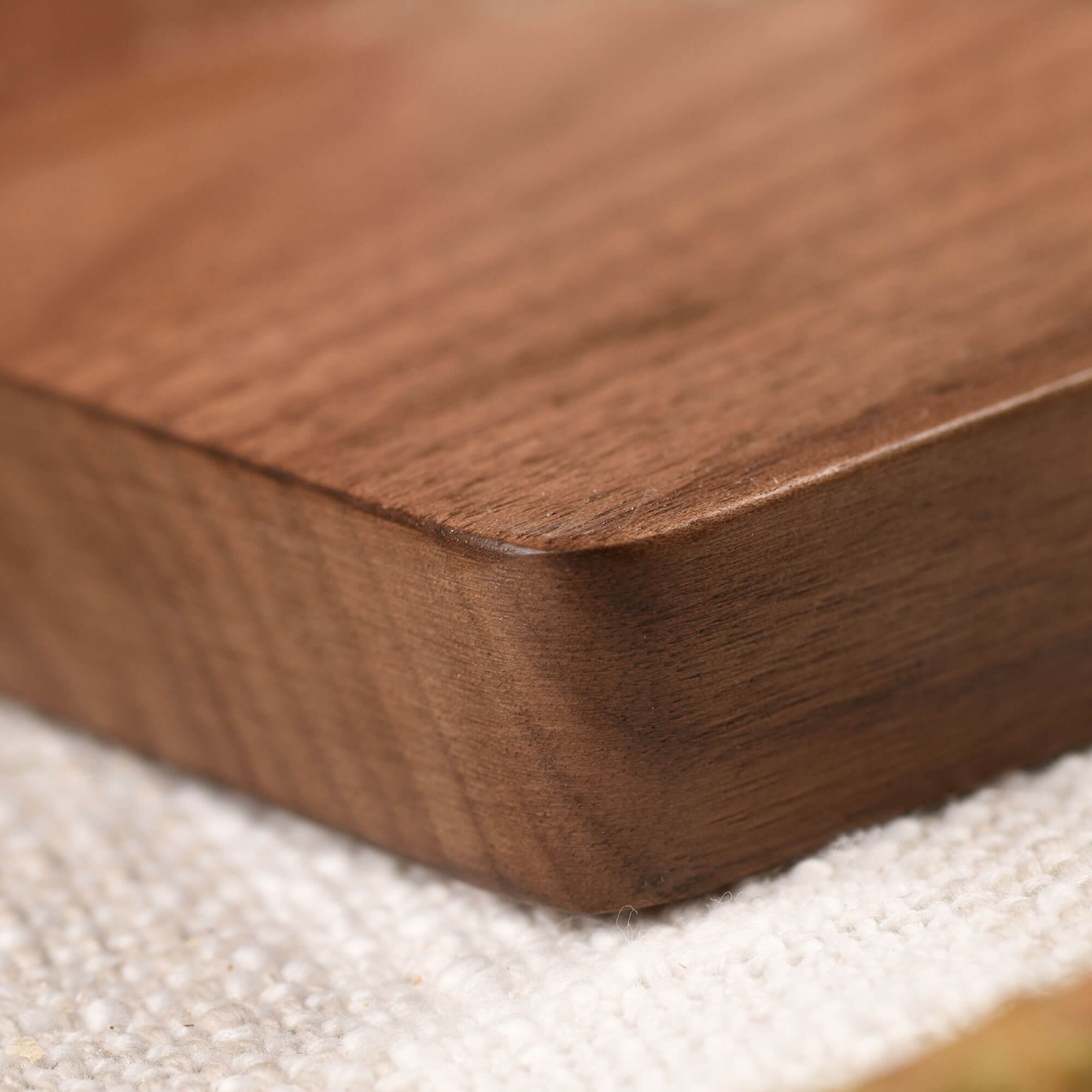 Closeup of wood texture of the corner of a walnut cutting board