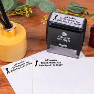 Golfer Address Stamp design impression on two envelopes next to self inking stamp body