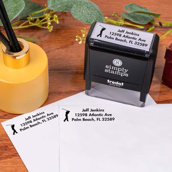 Golfer Address Stamp design impression on two envelopes next to self inking stamp body