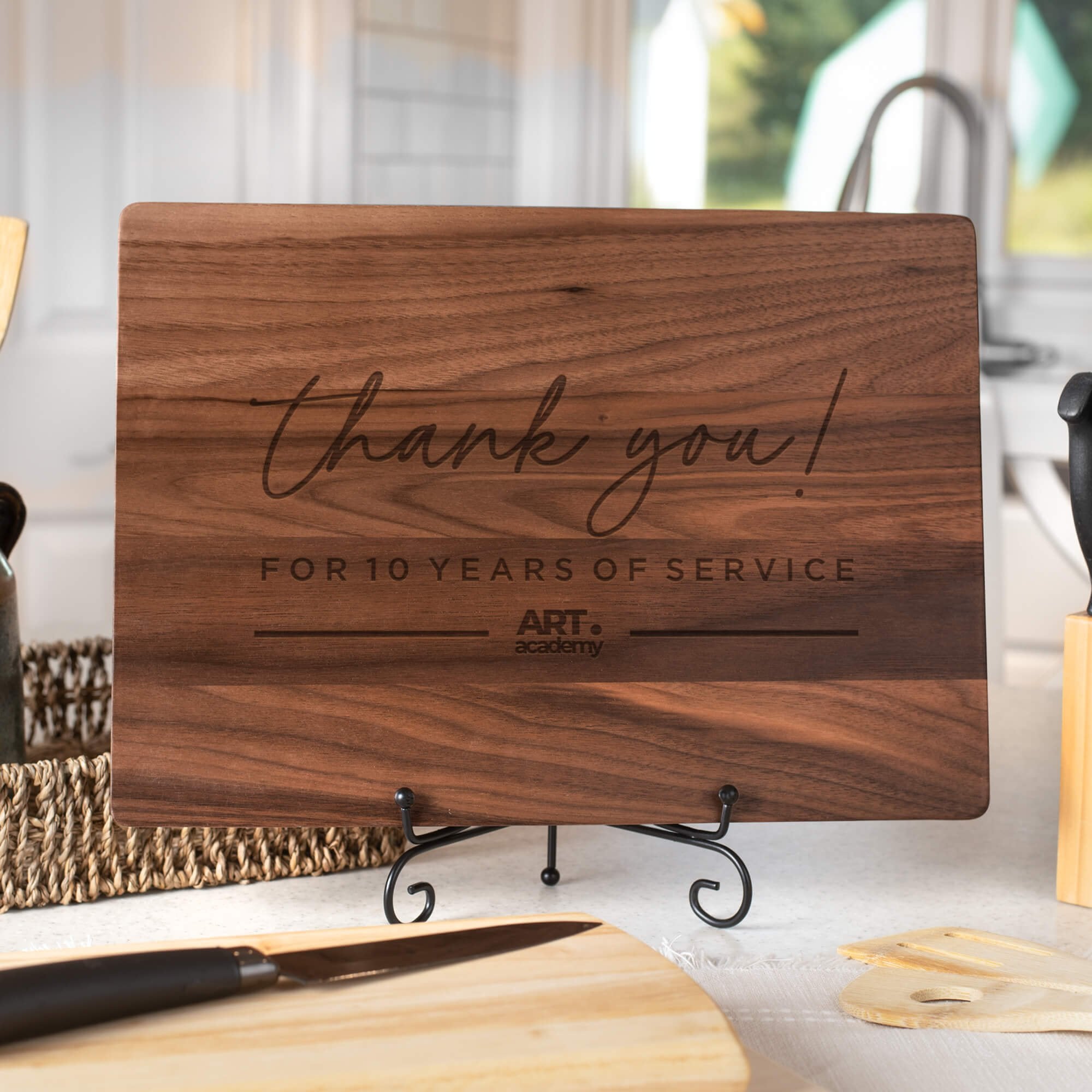 Large Cutsom Walnut cutting board displayed in a brightly lit kitchen  with "Thank You For Your Service" engraved into it