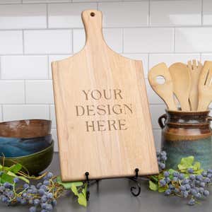 Your Design Here engraved into maple cutting board on a metal easel