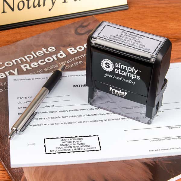 The Wyoming Rectangle Notary Seal self-inking stamp being used on a document