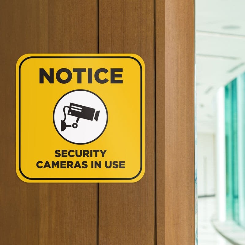 Yellow background custom sign with bold black text reads Notice security cameras in use and has surveillance camera icon Yellow background custom sign with bold black text reads Notice security cameras in use and has surveillance camera icon