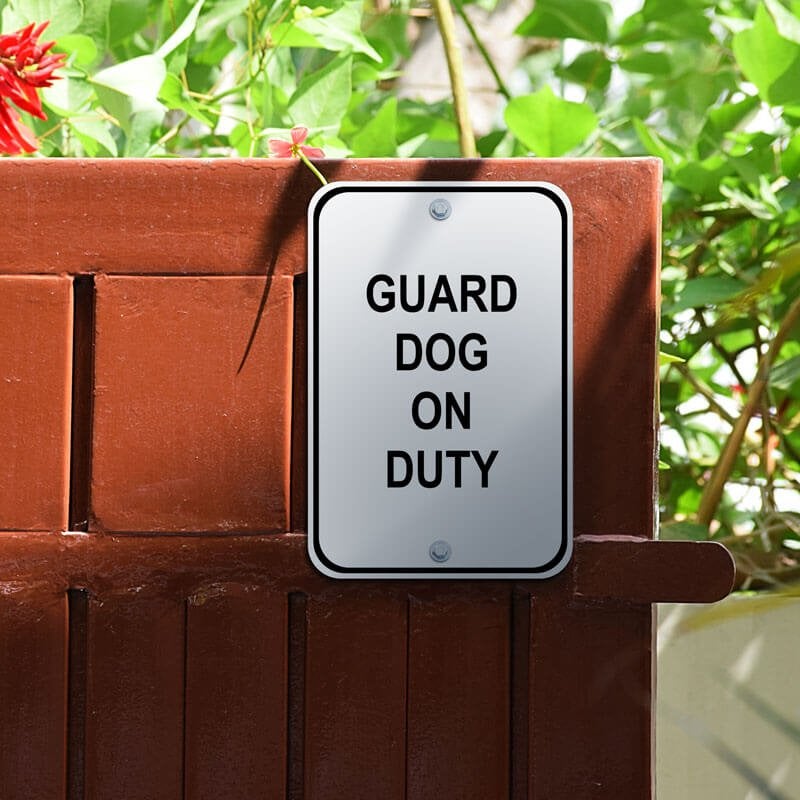 An Aluminum Sign for a Guard Dog on Duty