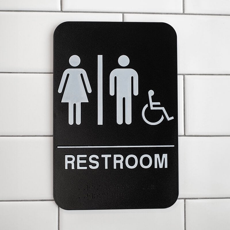 Black Unisex Handicap Sign Hanging on a Wall
