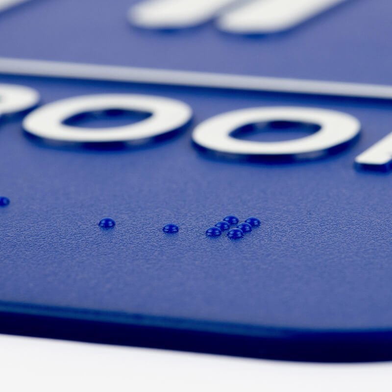 A close-up on the braille for the 9 x 6 ADA sign A close-up on the braille for the 9 x 6 ADA sign