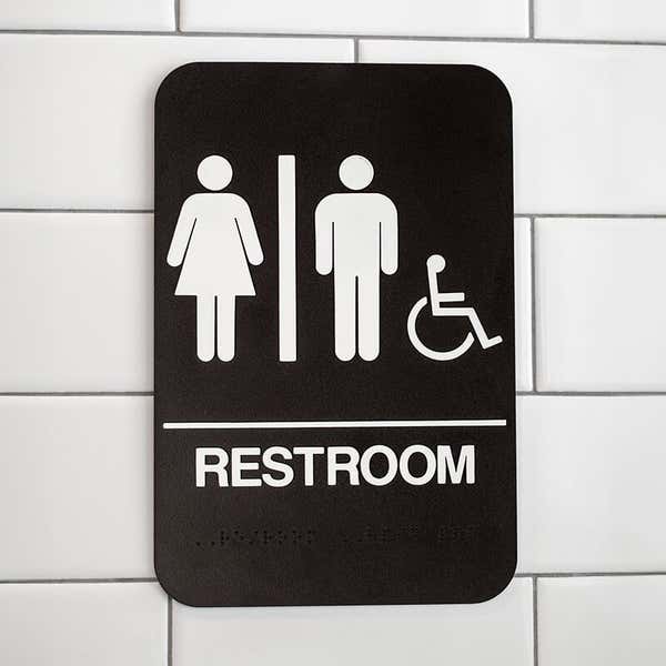 Brown Unisex Handicap Sign Hanging on a Wall