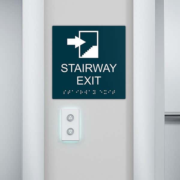 An ADA sign near stairs to show the stairway exit