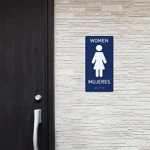 A women's restroom sign with the Spanish translation
