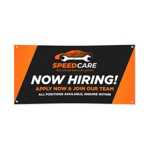 Black and orange vinyl banner with bold business branding and text, shown flat on white background with visible corner grommets