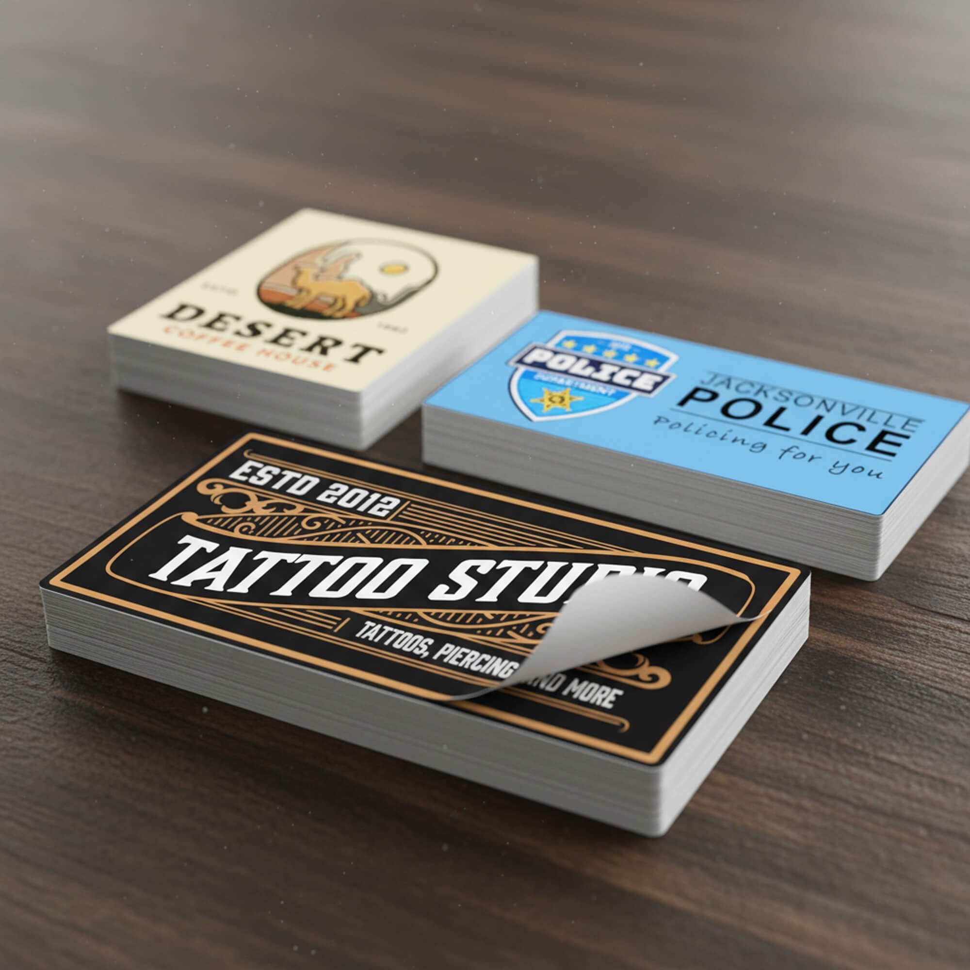 Three stacks of custom vinyl stickers with varying business designs