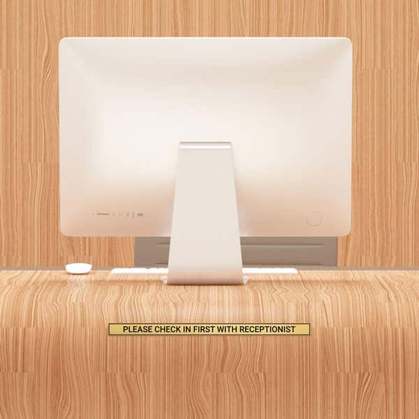 1x16 custom engraved brass sign displayed on a desk
