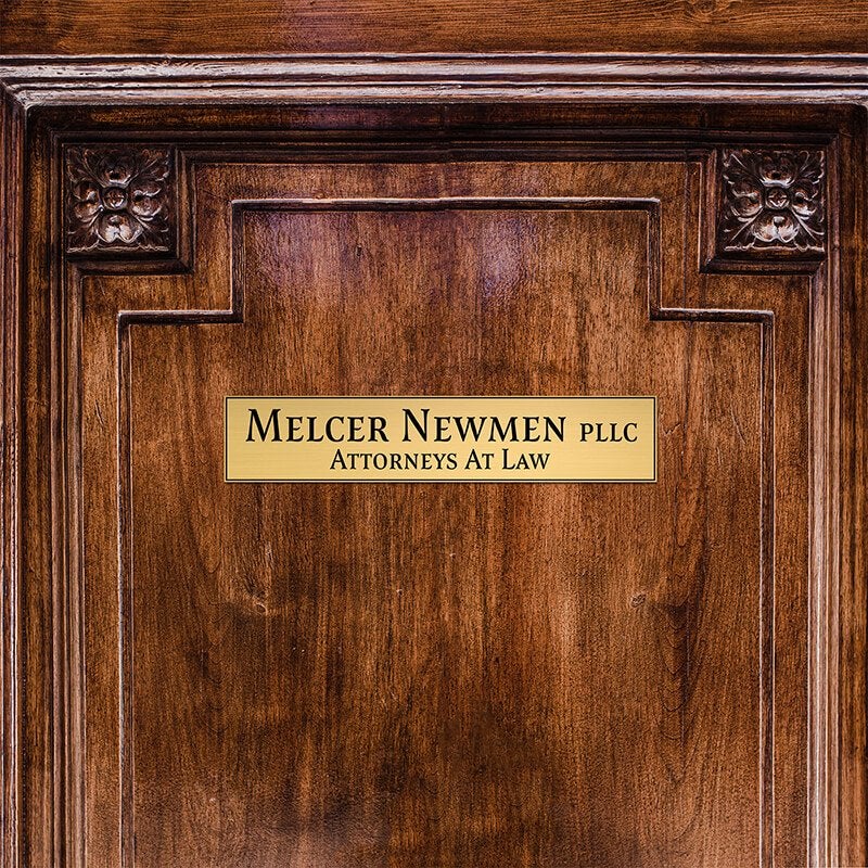 2x10 custom engraved brass sign displayed on a door