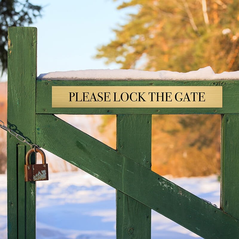 3x24 custom engraved brass sign on a fence 3x24 custom engraved brass sign on a fence