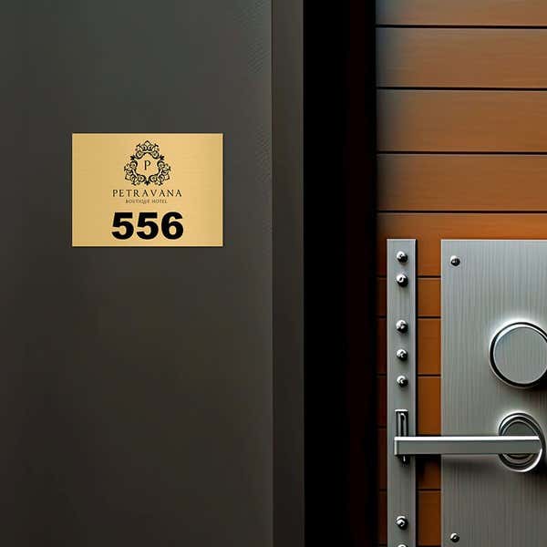 3x4 custom engraved brass sign displayed by a door
