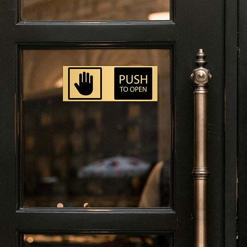 3x8 custom engraved brass sign displayed on a door