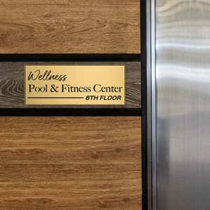 8x20 custom engraved brass sign displayed by an elevator