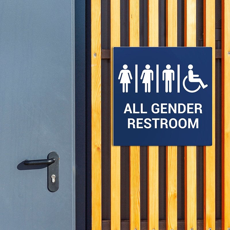 A blue engraved all gender restroom sign A blue engraved all gender restroom sign