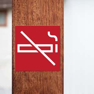 A red square engraved plastic sign with a no smoking symbol