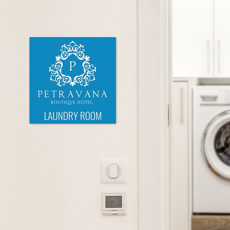 A baby blue engraved plastic sign for a hotel laundry room A baby blue engraved plastic sign for a hotel laundry room