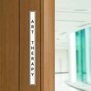 Engraved Sign Vertical 12" x 1" in a doorway