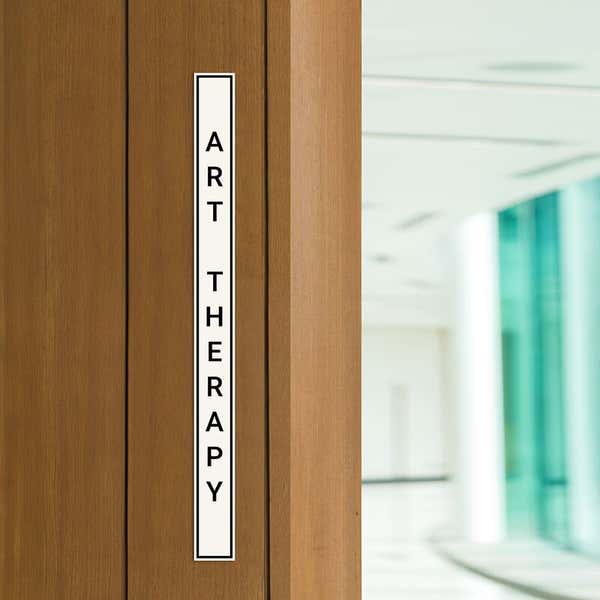 Engraved Sign Vertical 12" x 1" in a doorway