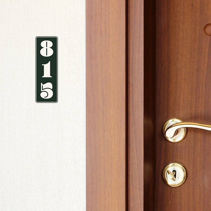 A green engraved plastic sign with a room number A green engraved plastic sign with a room number