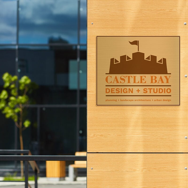 10" x 12" printed brass sign displayed next to an entrance 