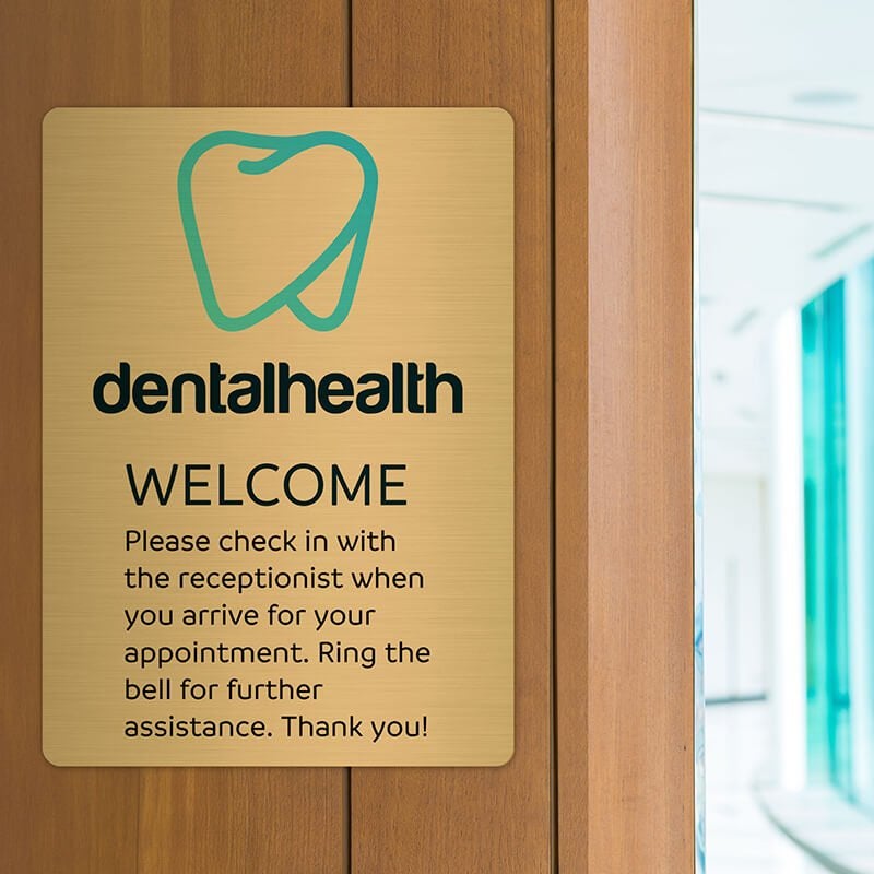 14x10 printed brass sign displayed in a dentist office