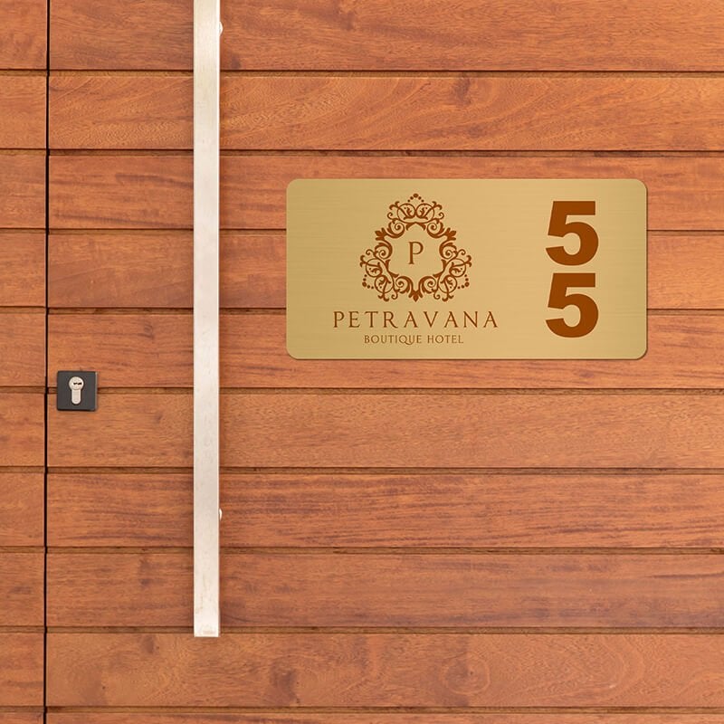 2x4 printed brass sign displayed on a wooden wall 2x4 printed brass sign displayed on a wooden wall