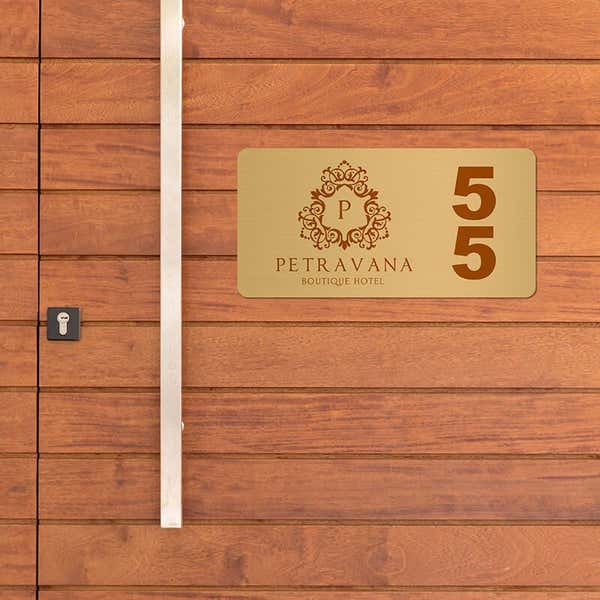 2x4 printed brass sign displayed on a wooden wall