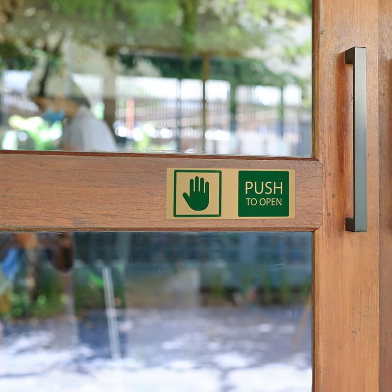 3x8 printed brass sign displayed on a door